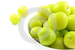 Fresh turkish can erik plum fruits in a small white bowl