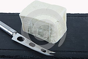 Fresh Turkish Feta Cheese. Healthy ingredient for cooking salad. Crumbled feta cheese on cutting board