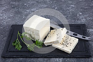 Fresh Turkish Feta Cheese. Healthy ingredient for cooking salad. Crumbled feta cheese on cutting board