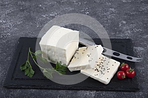 Fresh Turkish Feta Cheese. Healthy ingredient for cooking salad. Crumbled feta cheese on cutting board