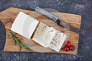 Fresh Turkish Feta Cheese. Healthy ingredient for cooking salad. Crumbled feta cheese on cutting board