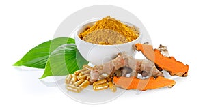 Fresh turmeric and turmeric capsules on white background