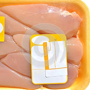 Fresh uncooked chicken breast meat pieces, packed and ready to cook