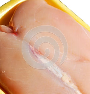 Fresh uncooked chicken breast meat pieces, packed and ready to cook