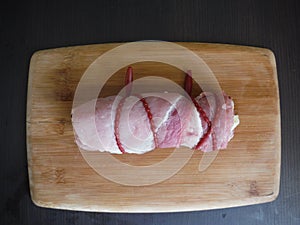 fresh uncooked meat chunk on wooden board