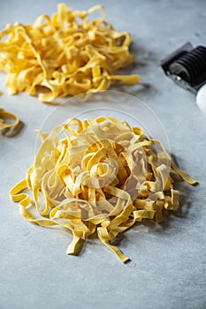 Fresh uncooked pasta nests on a gray background. Close up