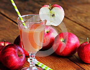 Fresh unfiltered organic apple juice on wooden table