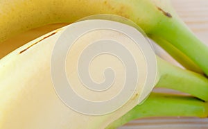 Fresh unpeeled bananas close up shallow depth of field