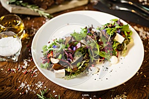 Fresh vegan salad. Avocado, couscous, melon, portobello, soybean, tofu on white plate. Delicious healthy mixed greens