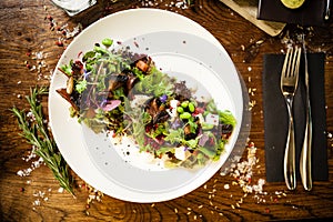 Fresh vegan salad. Avocado, couscous, melon, portobello, soybean, tofu on white plate. Delicious healthy mixed greens