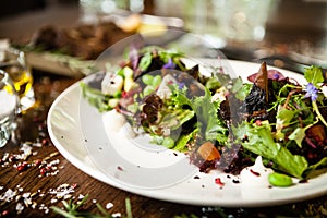 Fresh vegan salad. Avocado, couscous, melon, portobello, soybean, tofu on white plate. Delicious healthy mixed greens