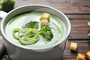 Fresh vegetable detox soup made of broccoli with croutons in dish on table