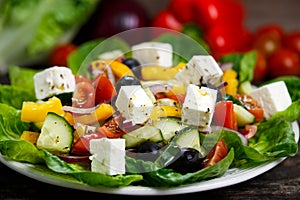 Fresh Vegetable Greek Salad with Feta cheese, black olives, olives oil, tomatoes, yellow pepper, onion, cucumber.