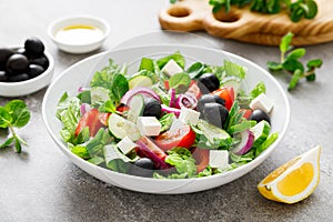 Fresh vegetable greek salad with lettuce, olives and feta cheese