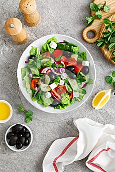 Fresh vegetable greek salad with lettuce, olives and feta cheese