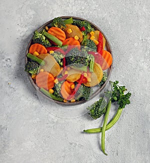 fresh vegetable mix in gray plate top view