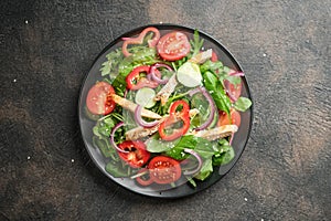 Fresh vegetable salad with chicken meat, herbs and olive oil