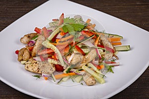 Fresh vegetable salad with chicken meat in white plate