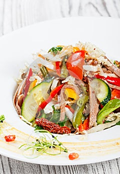 Fresh vegetable salad with cow tongue, spinach, green beans, tomatoes, sweet peppers, cabbage