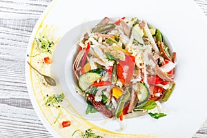 Fresh vegetable salad with cow tongue, spinach, green beans, tomatoes, sweet peppers, cabbage, mustard