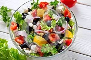 Fresh vegetable salad with feta cheese, fresh lettuce, cherry tomatoes, red onion and pepper