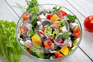 Fresh vegetable salad with feta cheese, fresh lettuce, cherry tomatoes, red onion and pepper