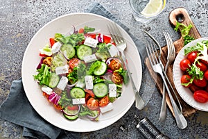 Fresh vegetable salad with feta cheese, fresh lettuce, cherry tomatoes, red onion and pepper