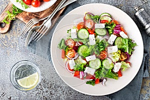 Fresh vegetable salad with feta cheese, fresh lettuce, cherry tomatoes, red onion and pepper