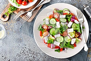 Fresh vegetable salad with feta cheese, fresh lettuce, cherry tomatoes, red onion and pepper