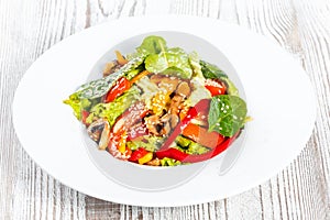 Fresh vegetable salad with lettuce, spinach, grilled mushrooms, tomatoes