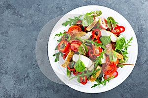 Fresh vegetable salad plate of tomatoes, spinach, pepper, arugula, chard leaves and grilled chicken breast. Fried chicken meat, fi