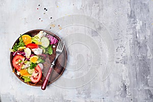 Fresh vegetable salad with red cabbage, cucumber, radish, carrots, sweet peppers, red onion and parsley