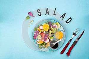 Fresh vegetable salad with red cabbage, cucumber, radish, carrots, sweet peppers, red onion and parsley