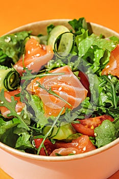 Fresh vegetable salad with salmon - tomatoes, avocado, cucumbers, and mix lettuce leaves.Fish salad. Healthy food. Isolated,