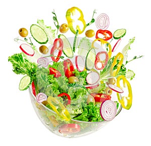 Fresh vegetable salad in transparent bowl with flying ingredients isolated on white.