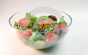 fresh vegetable salad in a transparent plate frillis cucumber tomato