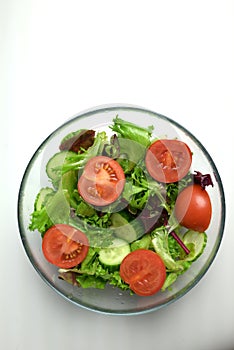 fresh vegetable salad in a transparent plate frillis cucumber tomato