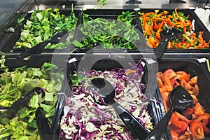 Fresh vegetable salads arranged in plastic dish