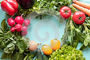 Fresh vegetables around on blue background. Healthy concept . Copy space.