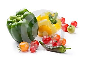 Fresh vegetables bell peppers, cherry tomatoes and chili close-up isolated on white background