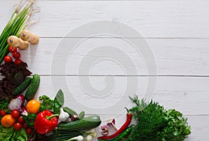 Fresh vegetables border on white wood background with copy space