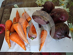 Fresh vegetables carrots and beets on the table, top view