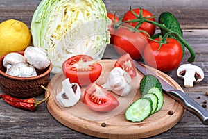 Fresh vegetables on a cutting board with a knife