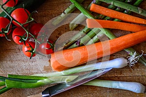 Fresh vegetables on a cutting board, tomatoes and asparagus close up