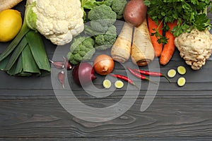 Fresh vegetables on dark wooden background. Mockup for menu or recipe. Top view with copy space