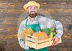 Fresh vegetables delivery service. Fresh organic vegetables box. Farmer hipster straw hat deliver fresh vegetables. Man
