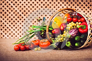 Fresh vegetables, fruits and lettuce in wicker basket