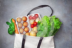 Fresh vegetables and fruits in natural eco friendly cotton bags top view. Zero waste food shopping and plastic free concept