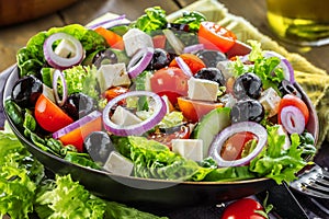 Fresh vegetables greek salad . Healthy food on wooden background.