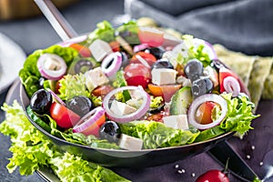 Fresh vegetables greek salad . Healthy food on wooden background.